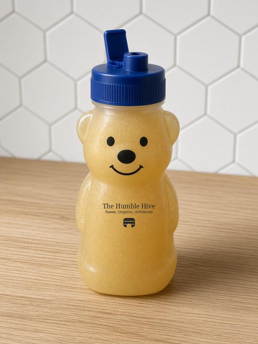 12-ounce The Humble Hive bear bottle with a blue lid, filled with crystallized honey